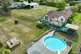 The yard is fully fenced, and there is also a greenhouse and firepit on the property.