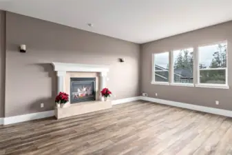 Living room with tall ceilings, gas fireplace and lots of natural light