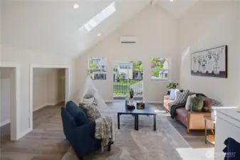 Upstairs boasts a bedroom and this large rec room / media room. Skylights makes it bright and cheery. A deck extends the length of the house so your friends can go out for a smoke between the game watching socials.