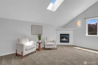 Primary sitting area with gas fireplace.
