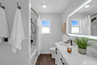 Jack & Jill full bath with double vanity and jetted bathtub.