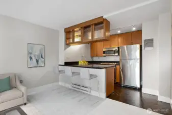 Plenty of room for a dining table.  Virtually staged breakfast bar.