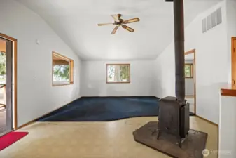 Looking at the living room with the wood stove that can heat the entire home.