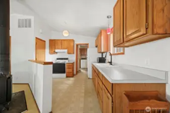 Looking at the kitchen with the back porch/laundry room beyond.