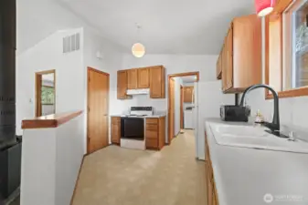 Looking at the kitchen with the pantry to the left of the range.