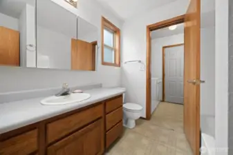 Looking through the full bath to the laundry/mud room and the back door beyond.