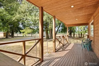 There is a great sitting porch that looks out toward the two smaller pastures with run-in sheds and paddocks.