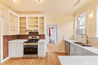 Timeless kitchen design featuring stainless steel appliances, open shelving, and warm character details.