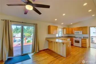 Kitchen and eating area with slider to wraparound deck