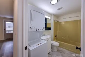 Full bath with partial remodel including new washer dryer, flooring, cabinetry, paint and lighting.