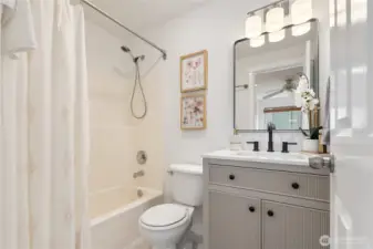 En suite bath with new vanity, light, mirror, faucet, sink