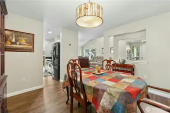 Dining room with living room and kitchen in background.