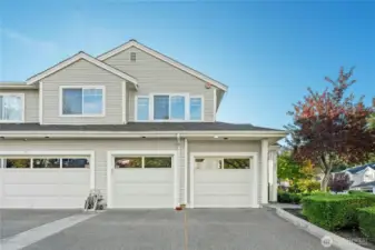 Double car garage with guest parking in from of garage door.