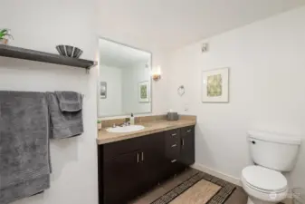 Large bathroom with granite tile vanity and tile floors.