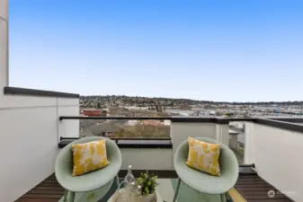 This cozy balcony invites you to enjoy your morning coffee or an evening glass of wine while soaking in picturesque views of the serene neighborhood and beyond.