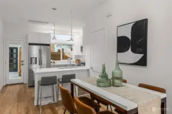 This dining area adjacent to the sleek kitchen creates a cohesive space perfect for casual meals and formal dinners.