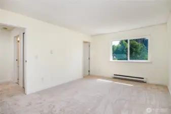 Primary bedroom is generously sized with brand new carpet.