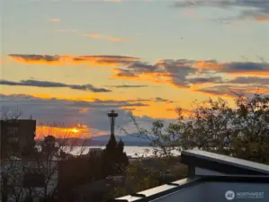 Unwind with mesmerizing Space Needle and Puget Sound views during a perfect golden-hour sunset.