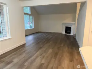 View of living room from dining area looking at gas fireplace