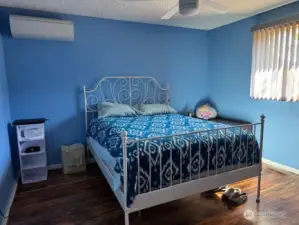 Primary bedroom is very large and see the mini-split on the wall.