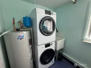 Laundry room with washer and dryer that comes with the house! newer hot water heater.