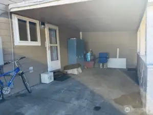 Now outside to the carport, storm door on the back door. the lockers are staying for storage.