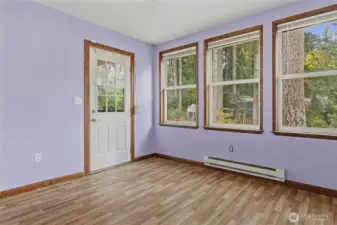 Airy and light room that leads to the back deck. Play room? Games? Sewing? Former resident had a free-standing closet in here and used this as her main floor bedroom.