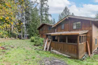 Back of garage on right with storage shed on back. Back of home in Center of Photo--so much potential for your Pacific Northwest Haven.