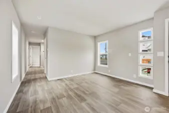 Other side of home, this hallway leads to 2nd bedroom and bath, laundry space and den.