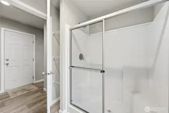 Shower with built in bench and small storage/linen space