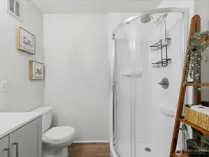 .75 bathroom with shower and storage room.
