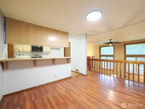 Casual dining with breakfast bar overlooks living room and kitchen