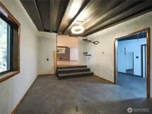 Office area with heated floors just down a few steps, workout room to the right