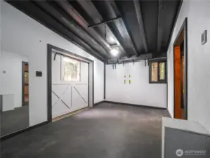 Workout room with heated floors and sliding door lead outside to large tiled patio.