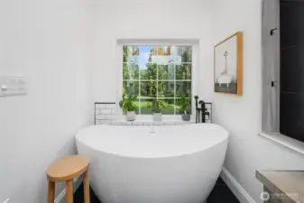 Elegant soak-in tub with views to the private backyard