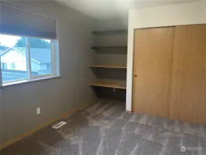 Bedroom 1 with built-in desk and storage space.