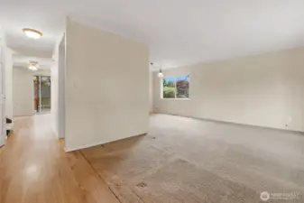 Straight ahead to the kitchen, kitchen dining area, and sitting area complete with a woodburning fireplace.