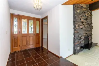 Wide foyer leads to family room & living room with floor to ceiling rockery