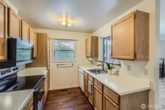 Being an end unit, extra light shines through the window and pass-through opening to the dining area.