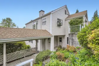 Beautiful landscaping welcomes you and your guests to the entryway of your new home.