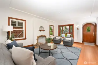 leads you into a spacious living room with a classic Batcheldor tile fireplace