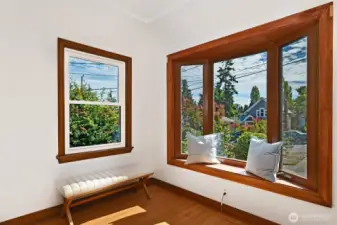 leads you into a spacious living roomwitCute entry with arched door and h a classic Batcheldor tile fireplace