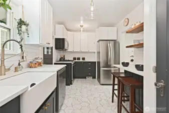 Recently remodeled kitchen with farmhouse sink and gas stove