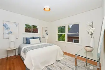 Larger main bedroom features windows on two walls