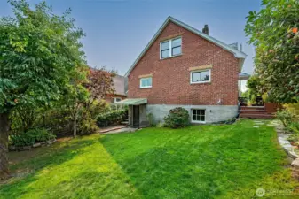 The large backyard, accessible from the side yard deck and the basement door,  allows for many uses and has enough space to accommodate a DADU or back yard studio.