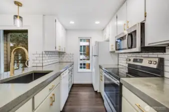 Updated kitchen with custom countertop and gold colored fixures