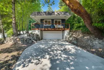 Sitting on the deck or in the living room feels like being up in a tree house. A beautiful madrona grows up over the driveway, a native PNW tree. Guests can park in the paved driveway or down on the street in the neighborhood.