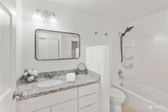 Bathroom with granite counter top.