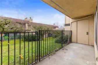 Patio with access to greenspace and extra storage.