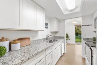 Granite kitchen counters and shaker style cabinets.